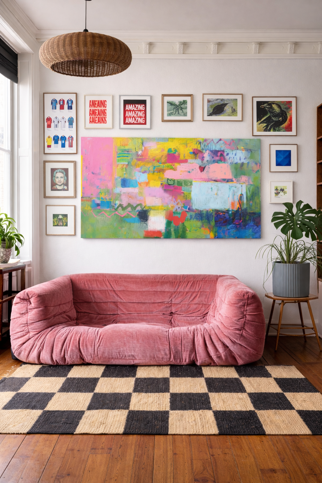 Large colorful abstract painting displayed in modern living room above pink sofa as statement wall art